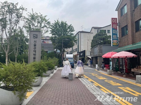서울공예박물관 앞 골목으로 외국인 관광객이 한복을 입고 거닐고 있다. [사진=백나은 기자]
